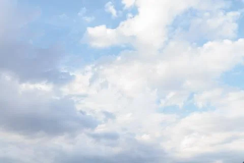 White fluffy clouds in the blue sky in summer Stock Photos