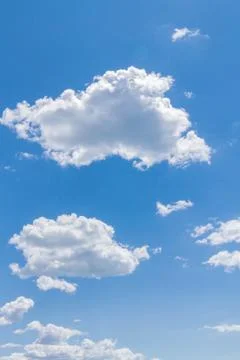 White fluffy clouds in the blue sky in summer Stock Photos