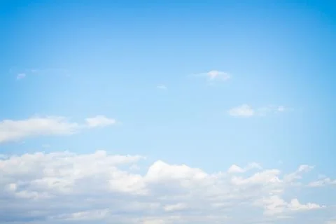 White fluffy clouds in the blue sky in summer Stock Photos
