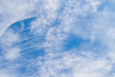 White fluffy clouds in the blue sky in summer Stock Photos