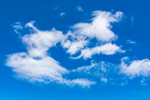 White fluffy clouds on the blue sky Stock Photos