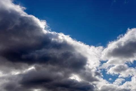 White fluffy clouds in the blue sky Stock Photos