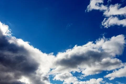 White fluffy clouds in the blue sky Stock Photos