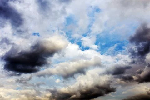 White fluffy clouds in the blue sky Stock Photos