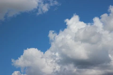 White fluffy clouds on blue sky in summer Stock Photos