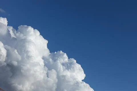 White fluffy clouds in a blue sky Stock Photos