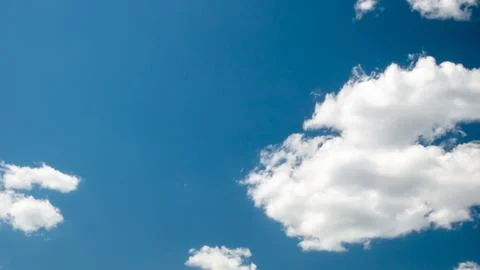 White fluffy clouds with blue sky background Stock Photos