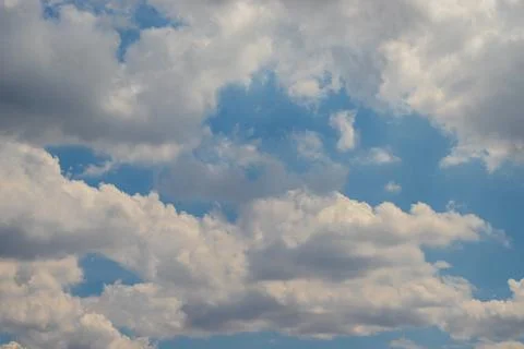White, fluffy clouds in blue sky. Stock Photos