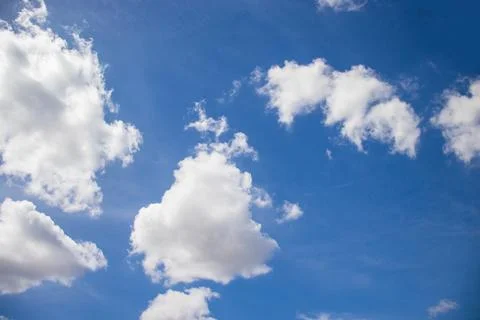 White, fluffy clouds in blue sky. Stock Photos