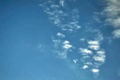 White fluffy clouds on a blue sky background Stock Photos