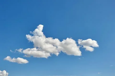 White fluffy clouds on a blue sky background Stock Photos