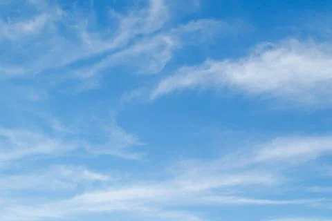 White fluffy clouds in the blue sky. Blue sky background and white clouds sof Stock Photos