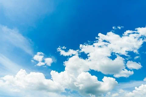 White fluffy clouds on blue sky in summer—cloudy skyline Stock Photos
