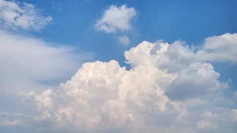White fluffy clouds in blue sky in autumn Stock Photos