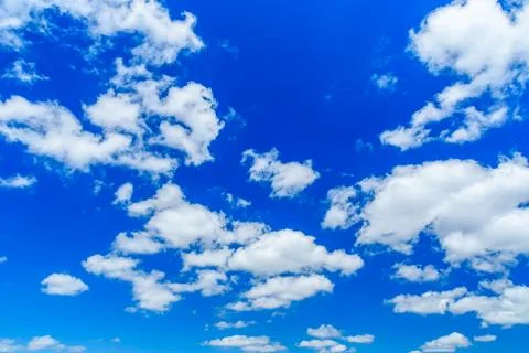White fluffy clouds in a blue sky Stock Photos