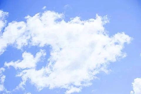White fluffy clouds in a bright blue sky during daytime Stock Photos