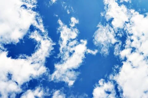 White fluffy clouds on a clear blue sky Stock Photos
