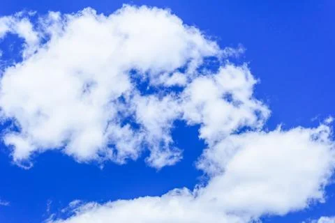 White fluffy clouds in a deep blue sky Stock Photos