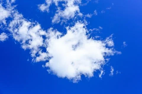 White fluffy clouds in a deep blue sky Stock Photos