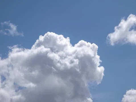 White fluffy clouds in the deep blue sky background Stock Photos