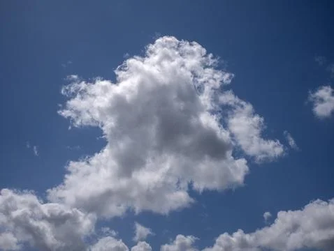 White fluffy clouds in the deep blue sky background Stock Photos