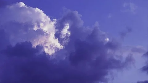 White fluffy clouds drift across the vast blue sky Stock Footage 324130869