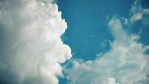 White Fluffy Clouds Drifting Slowly Across A Bright Blue Summer Sky Background Stock Footage 342211042