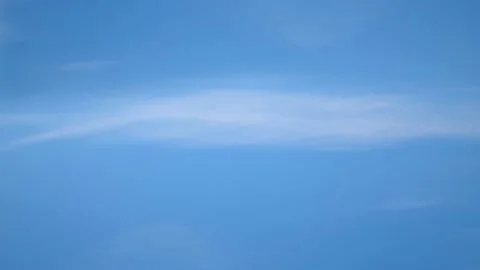 White fluffy clouds float across the blue sky Stock Footage