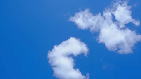 White fluffy clouds float in a bright blue sky during a clear day. cumulus Stock Footage 340272211