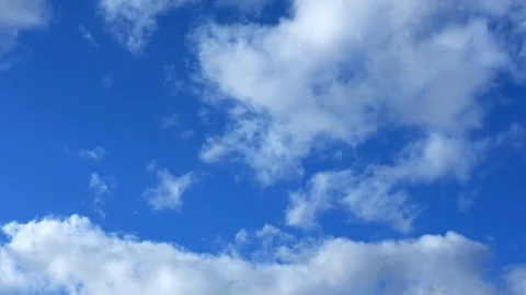White fluffy clouds floating on the blue sky. Stock Footage 129948599
