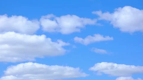 White fluffy clouds floating in a clear blue sky. Natural background, weather Stock Footage 341854549