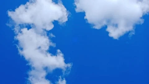 White fluffy clouds floating in a clear blue sky. Natural background, weather Stock Footage 341854636