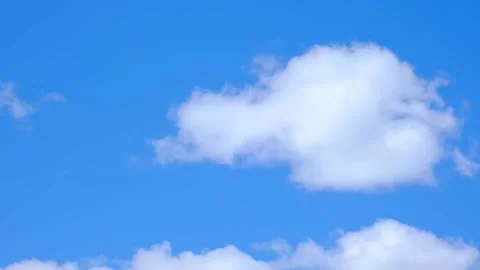 White fluffy clouds floating in a clear blue sky. Natural background, weather Stock Footage 341854680