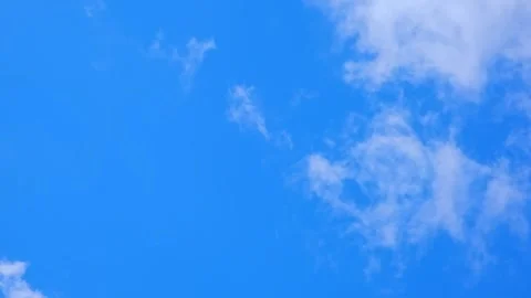 White fluffy clouds floating in a clear blue sky. Natural background, weather Stock Footage 341854723
