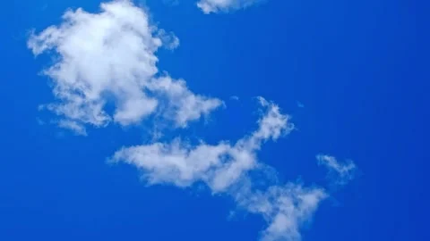 White fluffy clouds floating in a clear blue sky. Natural background, weather Stock Footage 341854769