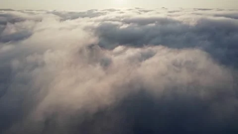 White fluffy clouds illuminated by warm light of the setting sun. Sunset in the 스톡 동영상 159538791