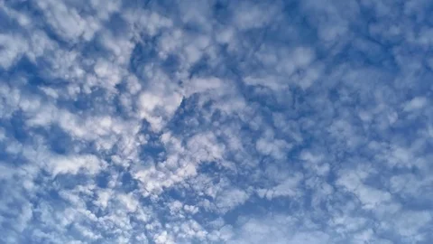 White fluffy clouds move fast on blue sky background Video stock 93491334