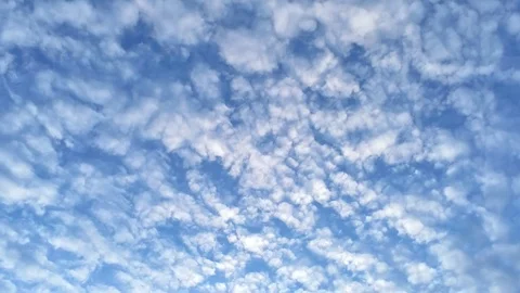 White fluffy clouds move fast on blue sky background Stock Footage 93491525