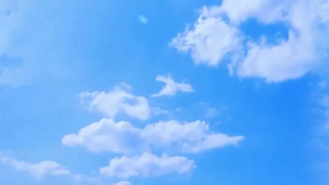 White fluffy clouds moving across the bright blue sky Stock Footage 345546180
