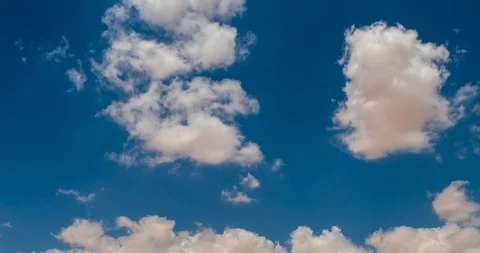 White fluffy clouds moving from back to front in the sky Stock Footage 93706616