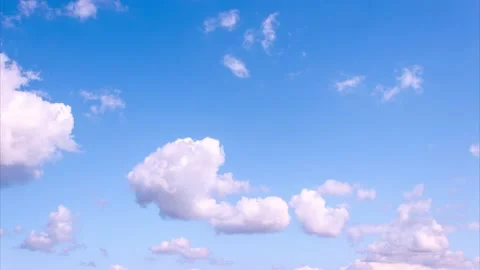 White fluffy clouds moving fast on blue sky time lapse Stock Footage 131366818
