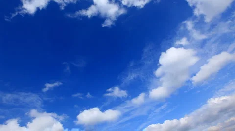 White fluffy clouds over blue sky Stock Footage
