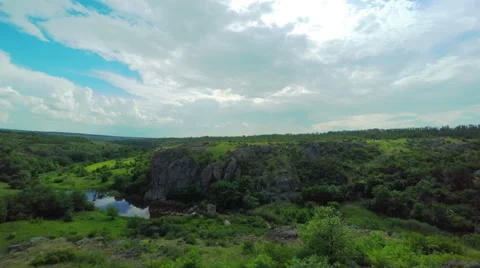 White Fluffy Clouds over the Canyon Stock Footage 64535226