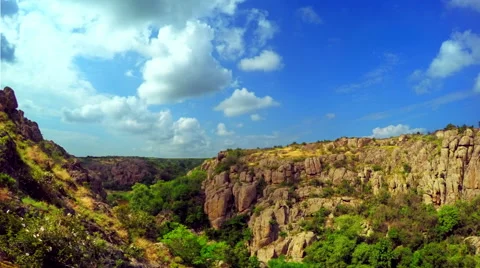 White Fluffy Clouds over the Canyon Видео 64536975