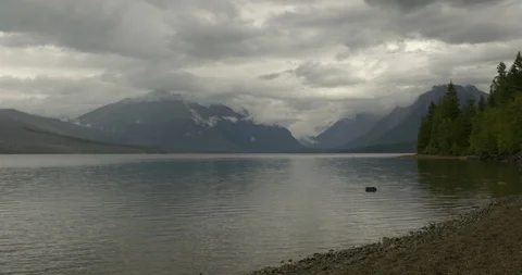 White fluffy clouds over mountains and lake Stock Footage 97607777