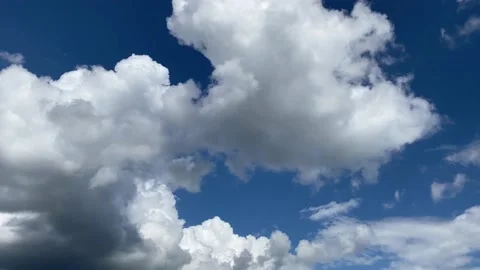 White fluffy clouds passing over a deep blue sky. Stock Footage 158304165