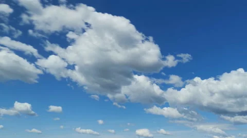 White fluffy clouds rolling on clear vibrant blue sky Stock Footage 111473931