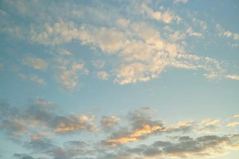 White fluffy clouds in the sky. Blue sky and cloud cover on a sunny summer da Stock Photos