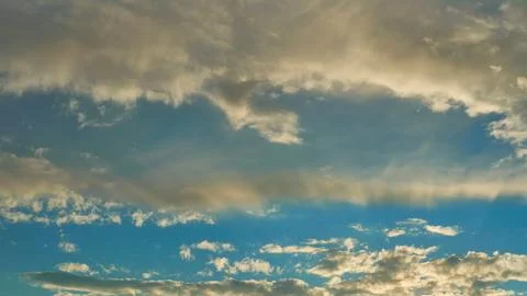 White fluffy clouds in the sky. Blue sky and cloud cover on a sunny summer da Stock Photos