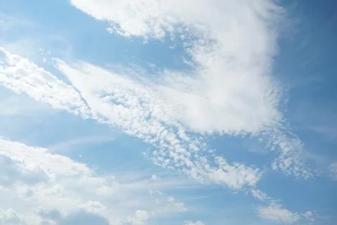 White fluffy clouds in the sky. Blue sky and cloud cover on a sunny summer .. Stock Photos